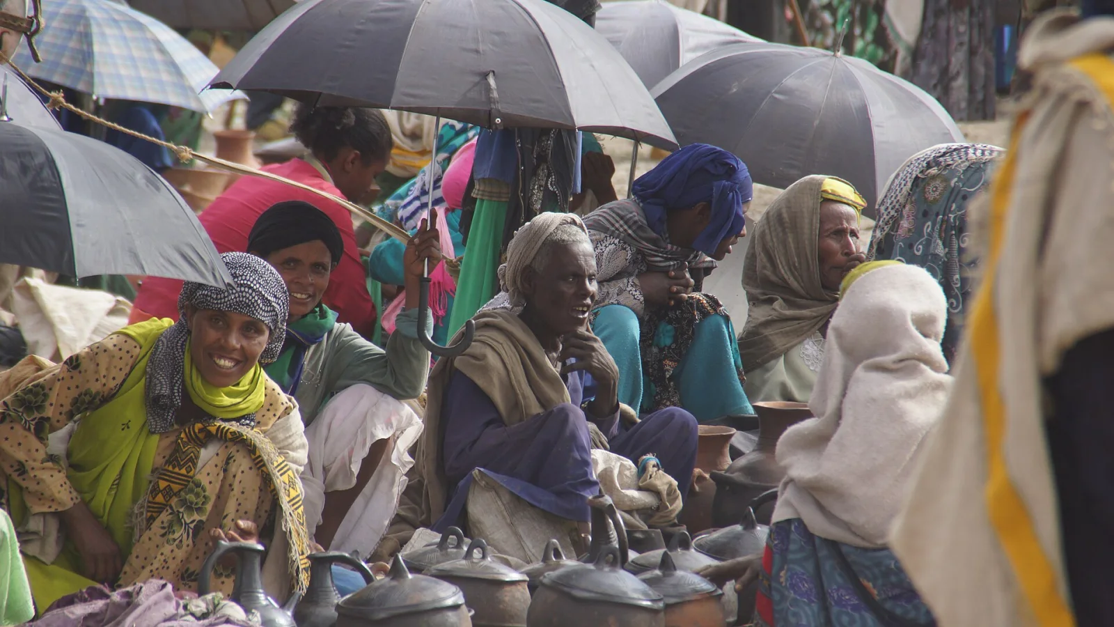 Ethiopian women sitting together and sharing a smile at a community gathering